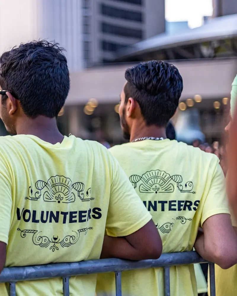 Two volunteers in matching shirts at an event